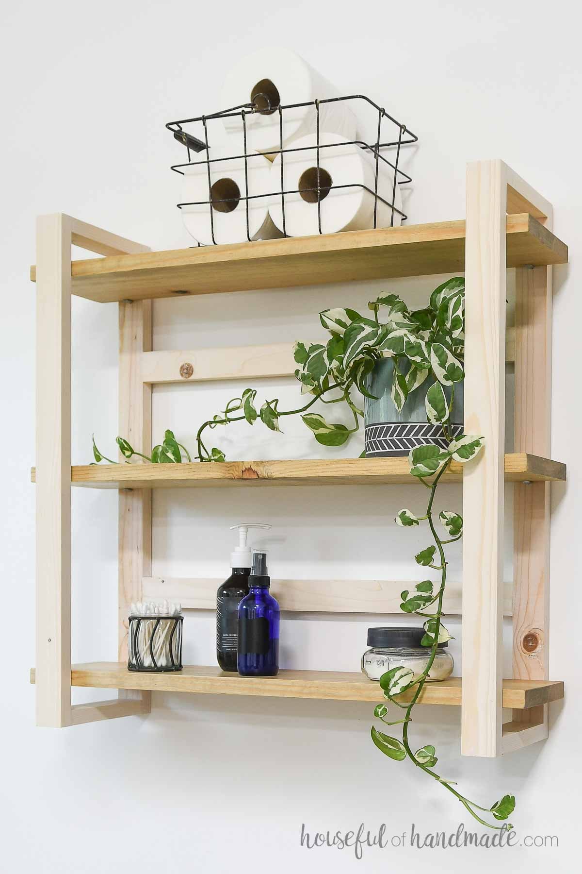 DIY wall shelves with bathroom items stored on them.