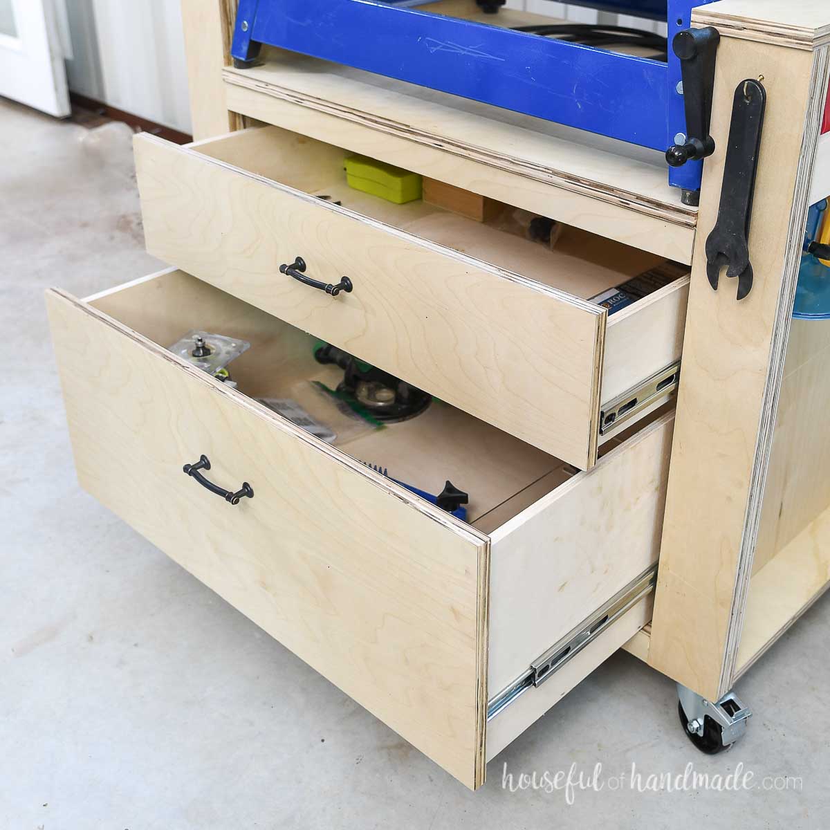 Heavy bottom drawers opened up in a rolling shop cart. 