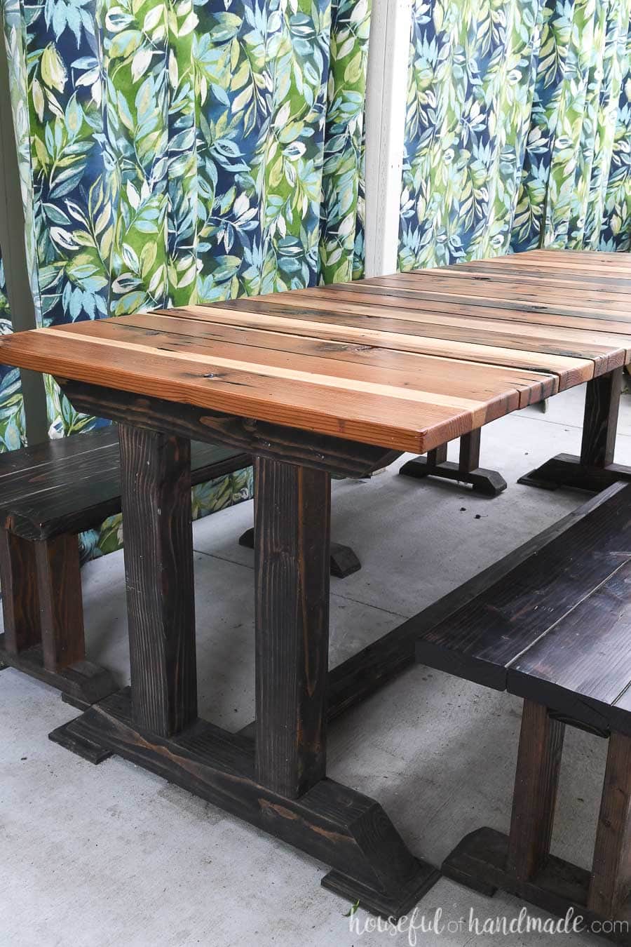 Beautiful wood table build from the picnic table plans on a patio.